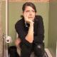 A pretty, tall dark-haired girl desperately runs off to the bathroom to take a piss. We are treated to a simple, stationary camera view of her pissing while sitting on a toilet and then wiping. About 2 minutes.